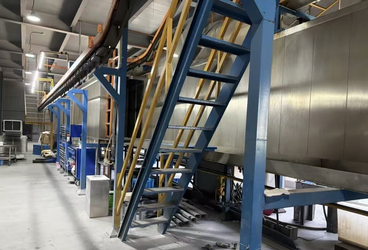 Automated pre-treatment, powder coating and curing line